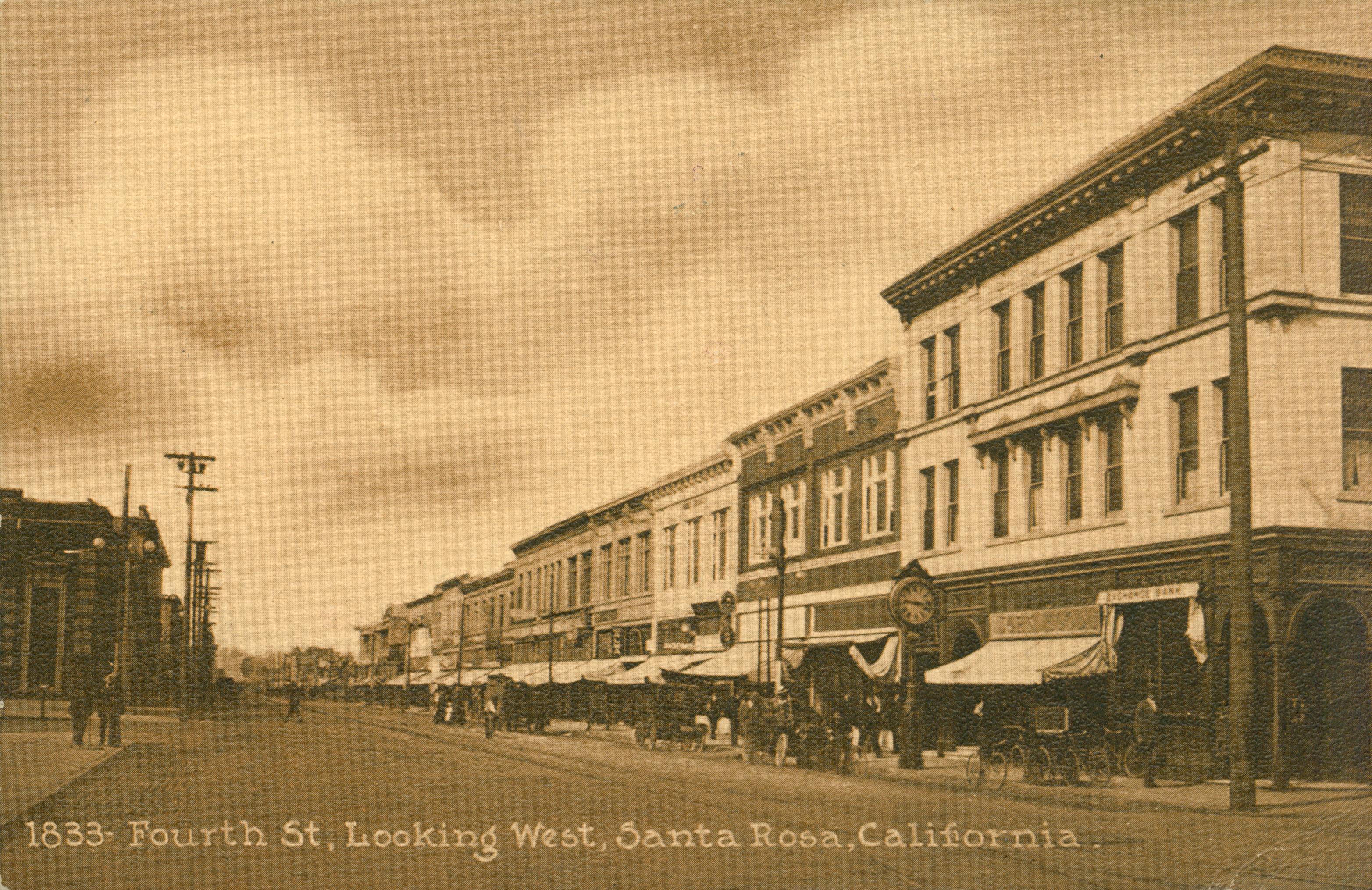 Shows a street in Santa Rosa, lined by buildings